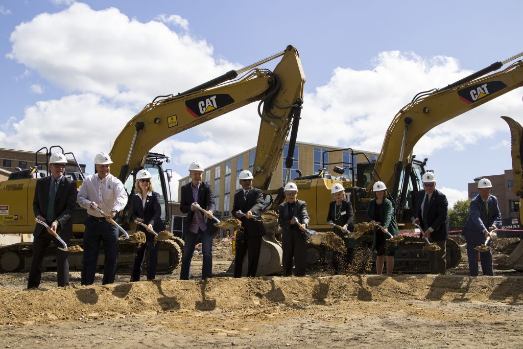 Donors break ground with their shovels at the construction site