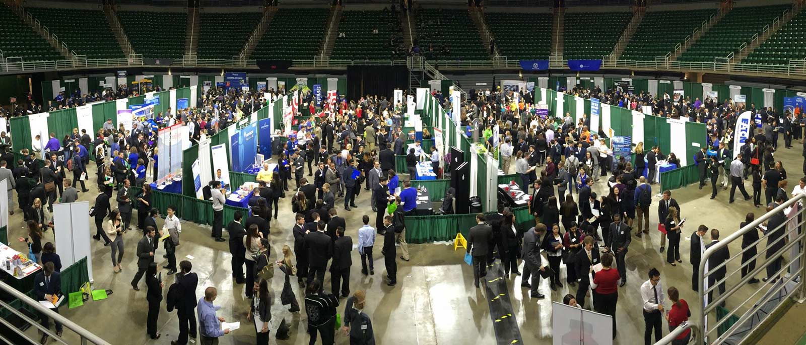 Hundreds of students and recruiters mingle on the floor of the Breslin Student Events Center at a recruiting fair