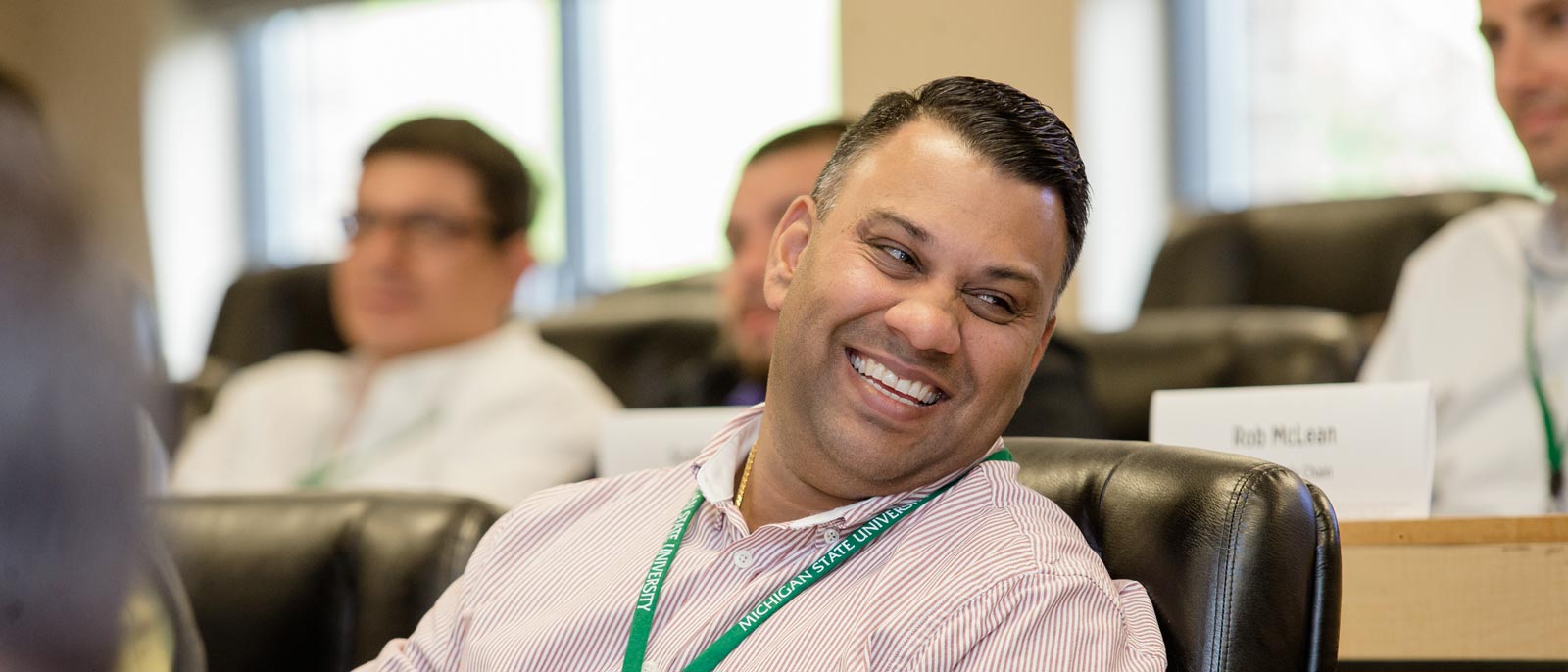 Man smiling while attending an executive development course at MSU