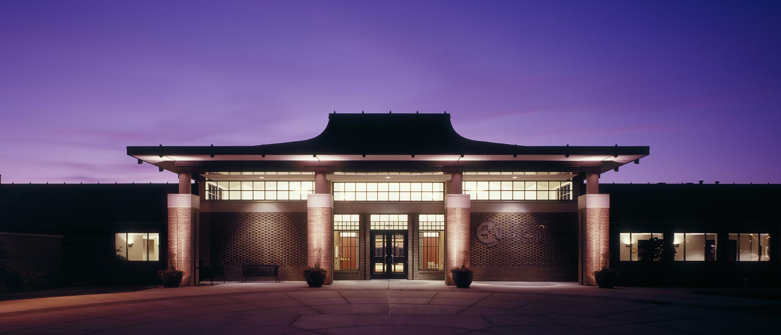 Photo of the front entrance to the James B. Henry Center for Executive Development at dusk.