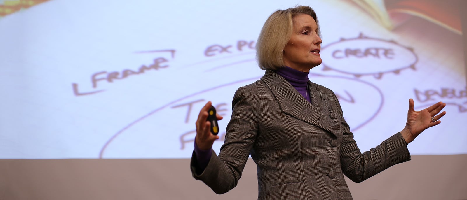 Michigan State University MBA Faculty member teaching in front of a project screen displaying slides