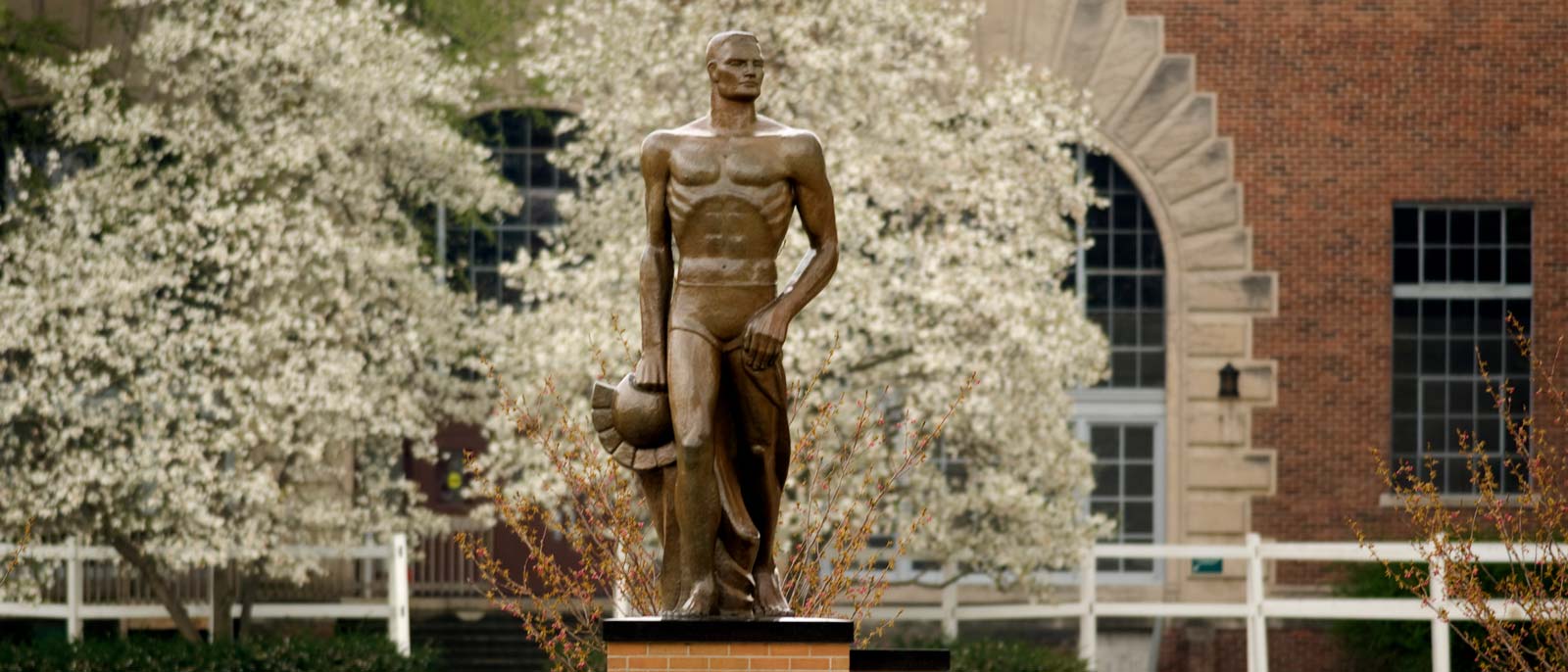 Spartan Statue on a spring day with trees blooming in the background