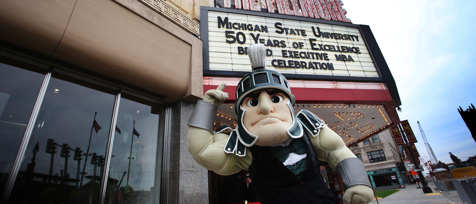 Sparty the mascot dressed in a tux while standing in front of the Fillmore in Detroit, Michigan