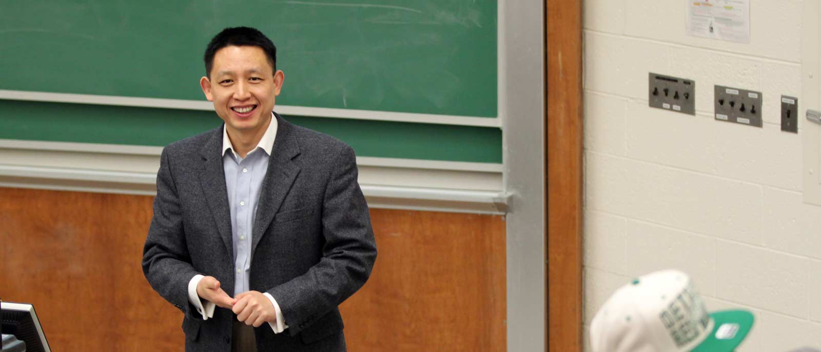 Accounting and Information Systems' faculty member, Xuefeng Jiang, smiles as he stands in front of the classroom during an accounting course at MSU.