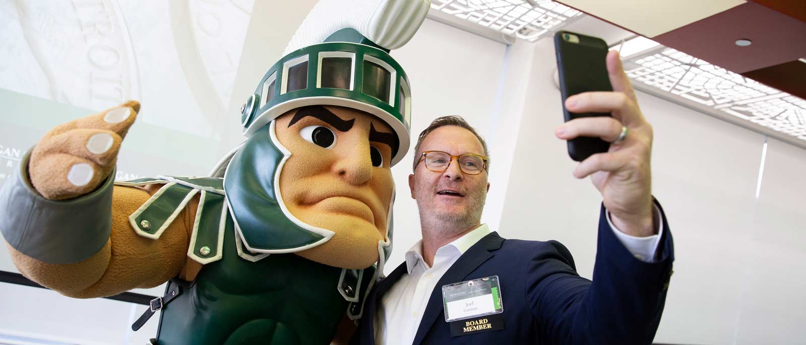 Detroit Executive Forum Board Member takes a selfie with Sparty