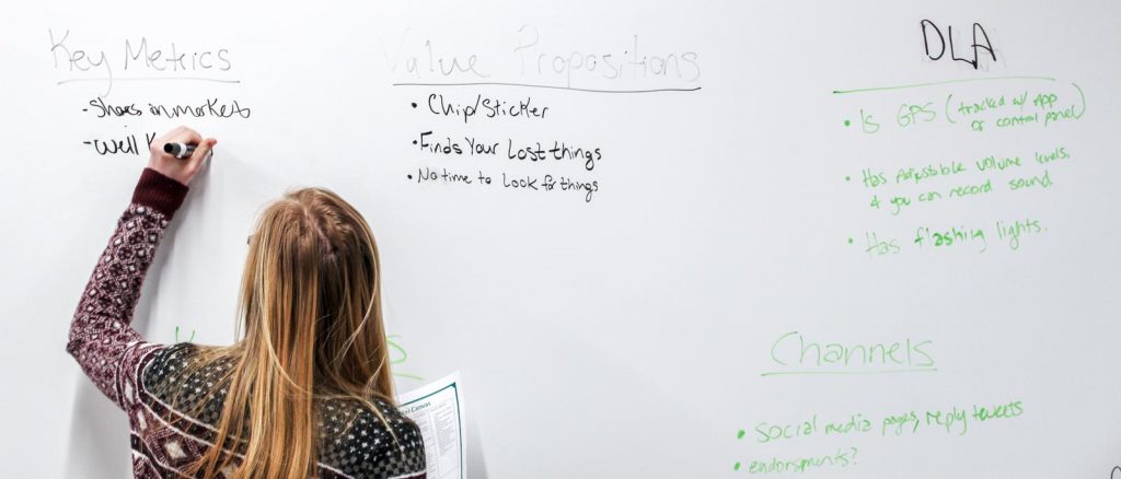 Female student writes on a white board