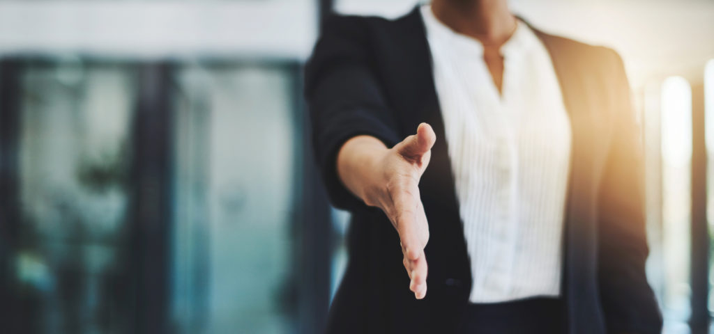 Cropped shot of a businesswoman extending her arm for a handshake