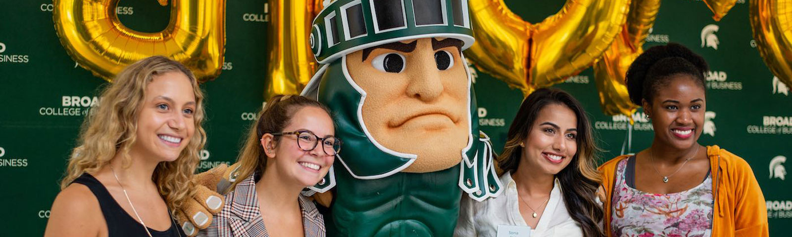 Broad College of Business undergraduate students posing with Sparty for a group photo
