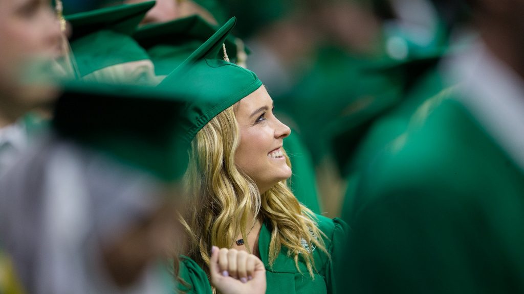 Student smiles at graduation