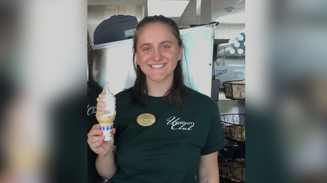 Annalise Shaw holds an ice cream cone at her workplace