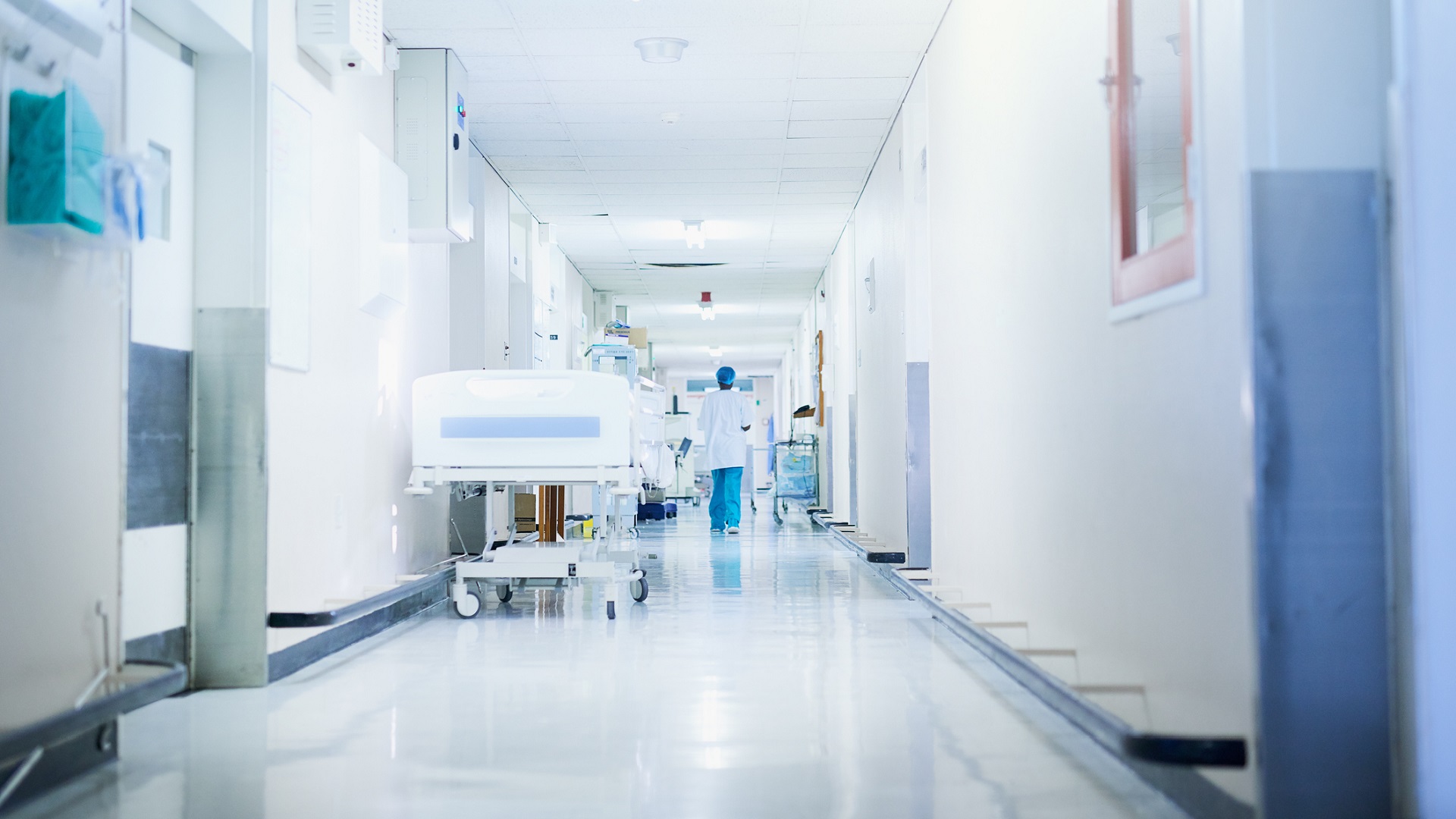 Rearview shot of a surgeon walking down a hospital corridor