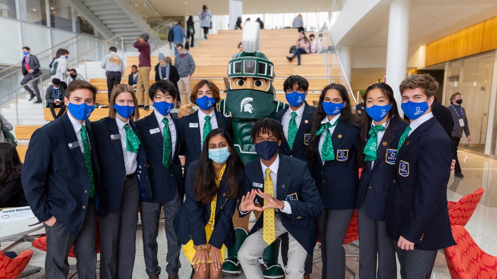 MSU Broad students at Michigan DECA Conference posing with Sparty