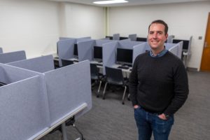 Nick Hays, associate professor of management, stands inside the Broad Behavioral Lab