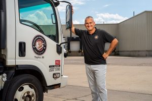 EMBA Class of 2018 alumnus Spiros Assimacopoulos standing with a delivery truck for his company, Michigan Bread