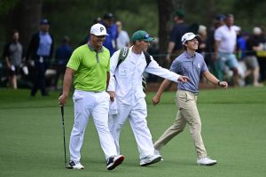 James Piot, his caddy and opponents walk the Masters course during a practice round.