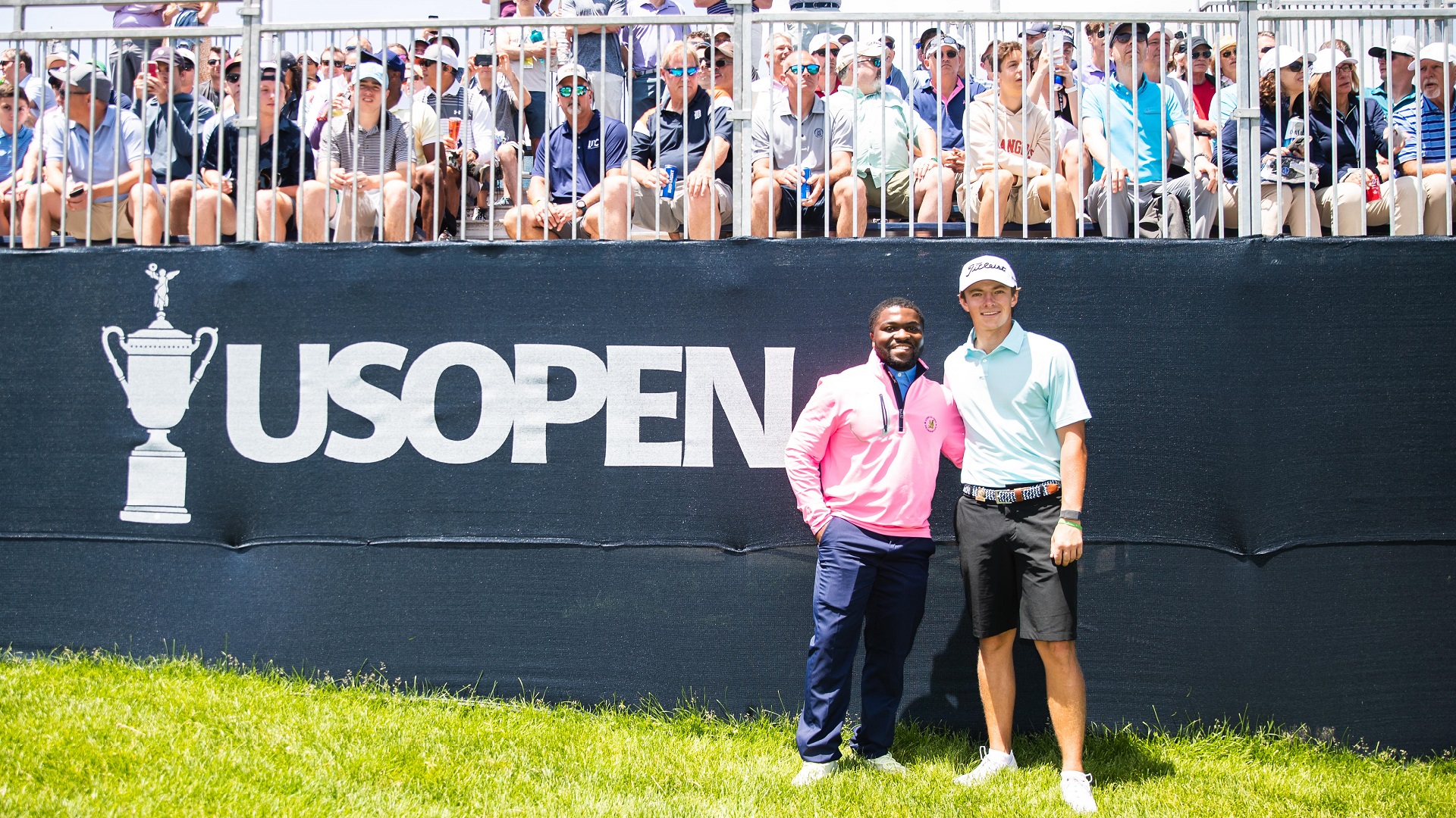 Broad students Darryl Ervin and James Pion pose in front of a crowd at the US Open.