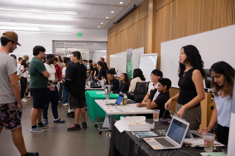 Students organizations with displays and tables engage with groups of students.