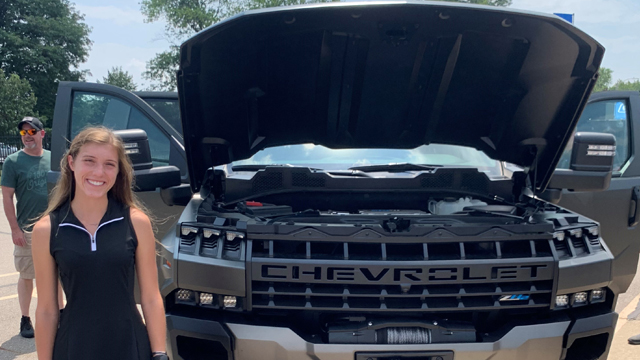 Maggie Beckeman in front of a Chevrolet truck