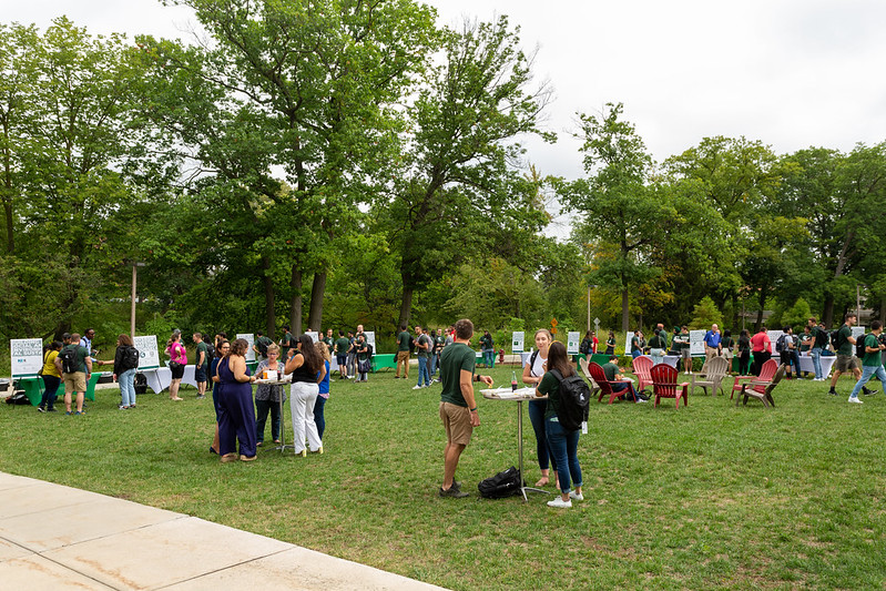 Students talking and networking outside on the Minskoff Pavilion Secchia Lawn at the 2022 MBA Welcome Picnic.