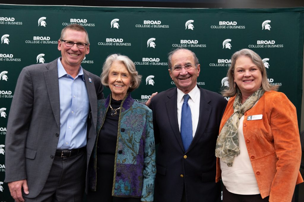 Wendy's CEO Todd Penegor, MSU alumni Edward and Jeannie James and Interim Dean Judith Whipple pose in front of a Broad College branded step and repeat at the 2022 Warrington Lecture.