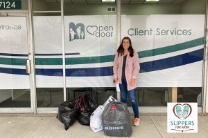 Michelle Garr dropping off bags of slippers to a client services building through her Michigan nonprofit Slippers For Mom.