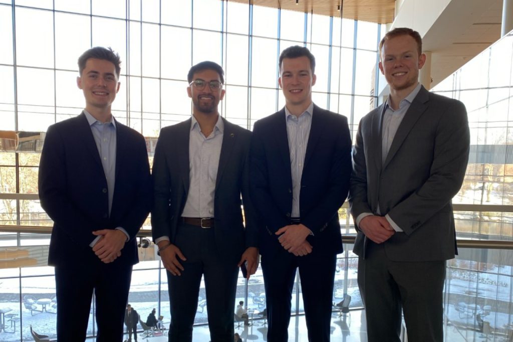 Four FMI scholars pose in the Minskoff Pavilion after winning a case competition.