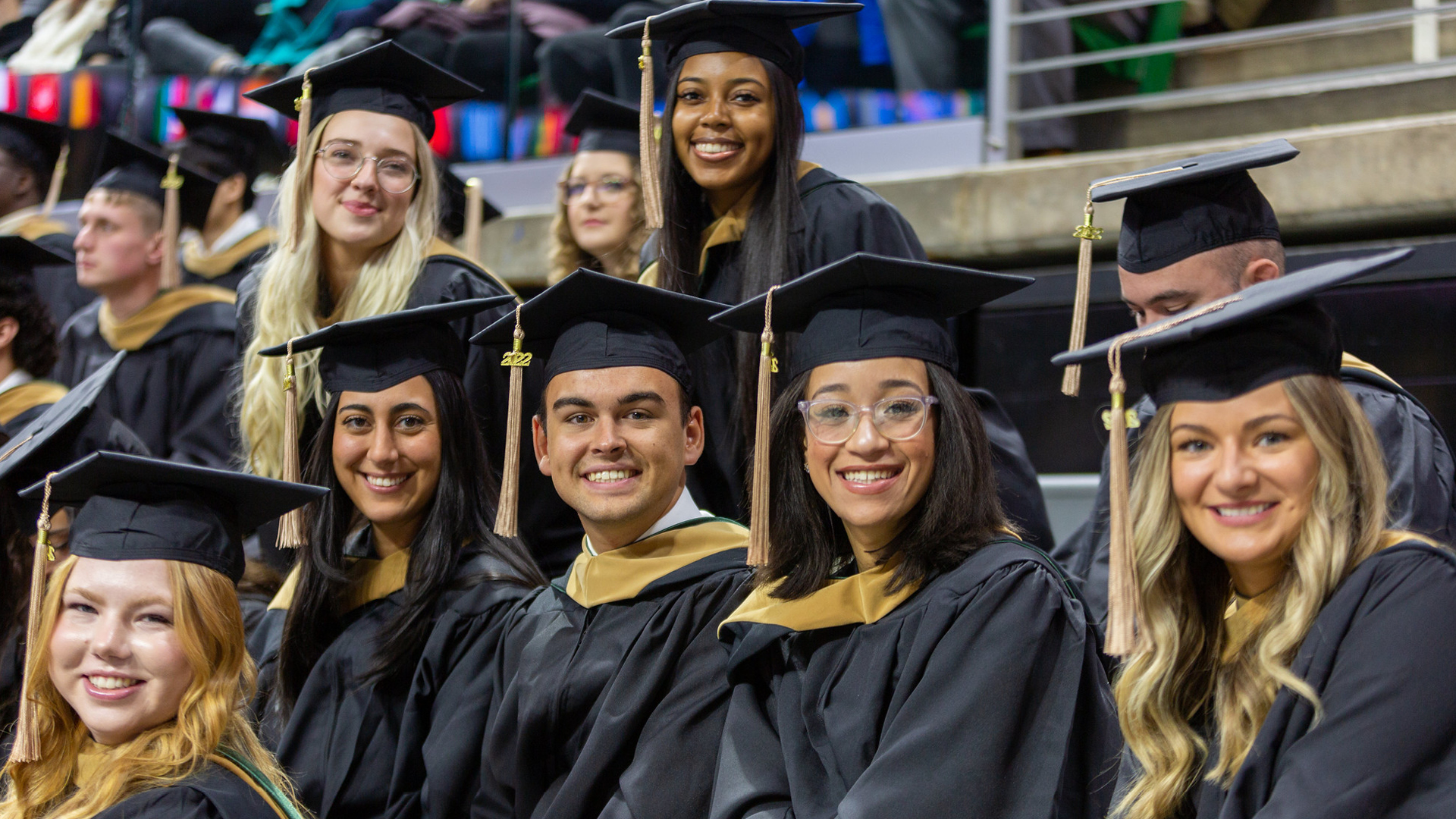 Broad master's students pose for a picture at the 2022 commencement ceremony in the Breslin Center.