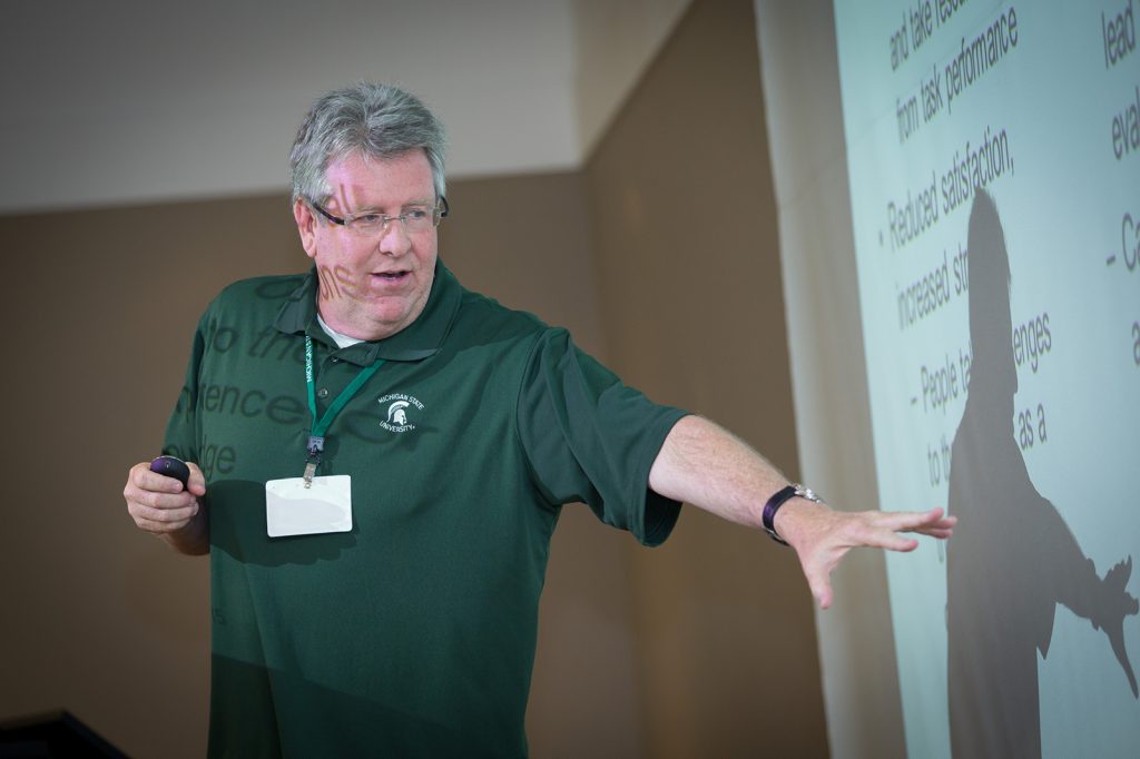 Don Conlon teaching a class, pointing at a presentation slide.