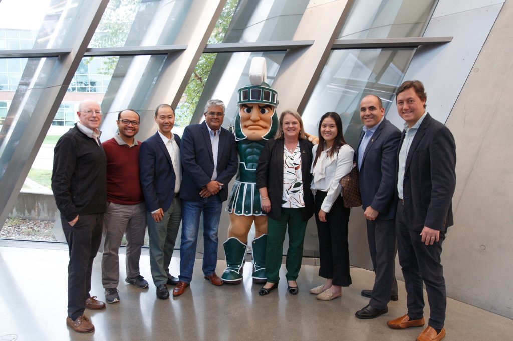 International Alumni Advisory Board members pose with Sparty at the MSU Broad Art Museum for an event.