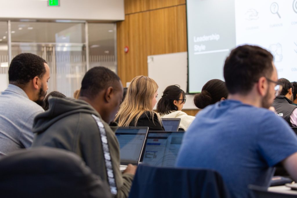 Full-Time MBA students taking notes in class.