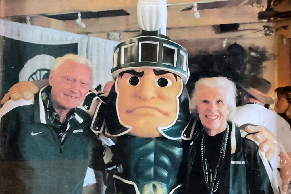 James and Claudia Prescott pose with MSU's mascot Sparty.