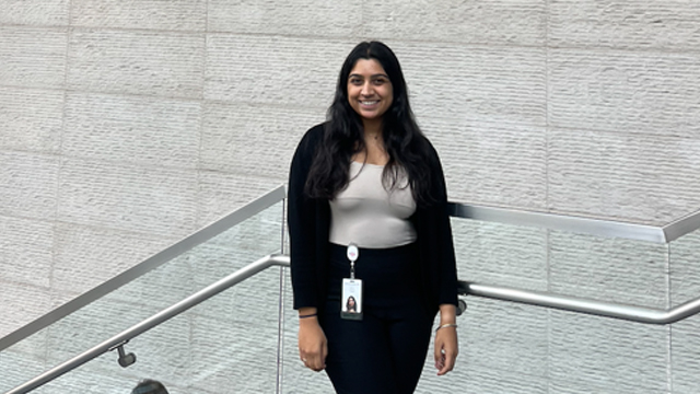 Ipsa Patel smiling and posing on a staircase