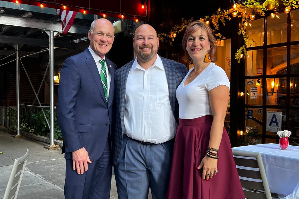 Ryan Meliker and his wife, with Jim Anhut in New York City outside a restaurant.