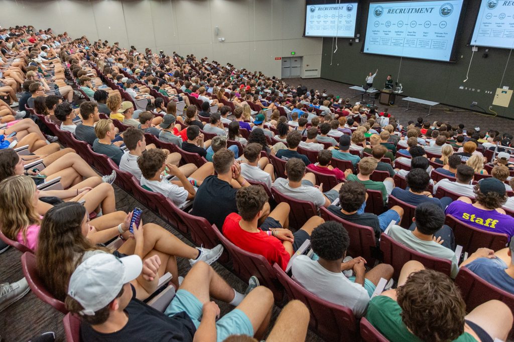 The packed auditorium classroom in the Broad College Complex during Welcome Week, as seen from the back row.