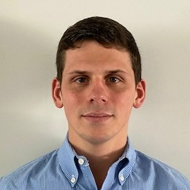 Headshot of man wearing blue button up shirt with white background