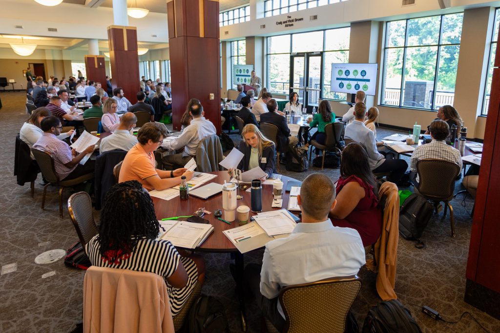 MSU Henry Center atrium filled with Executive MBA students at orientation.