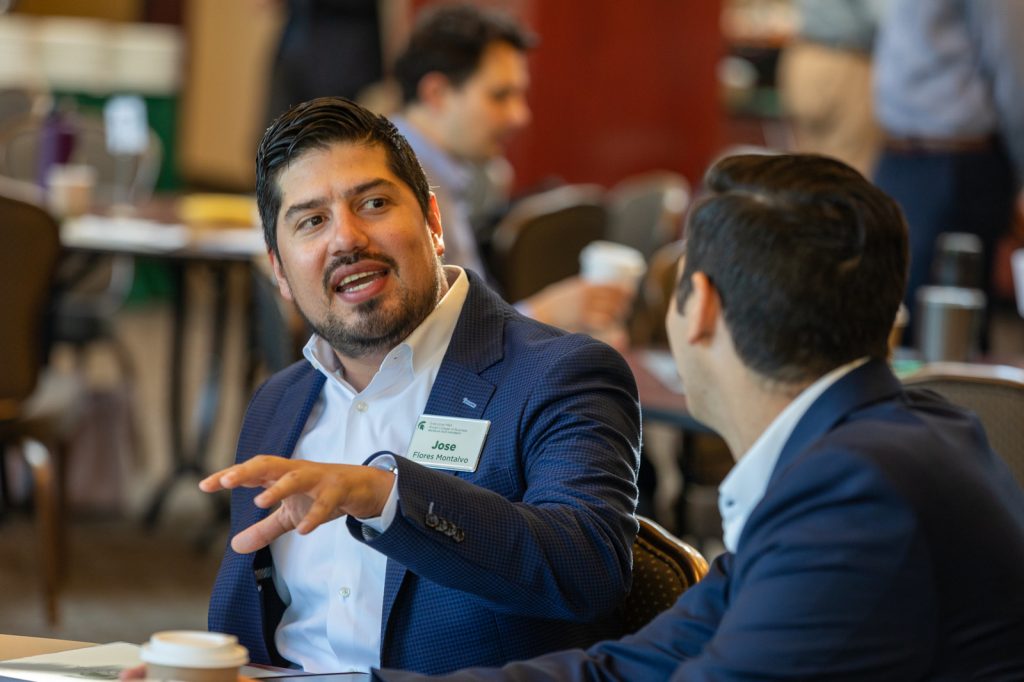 Two Broad Spartan EMBA students talking at orientation.