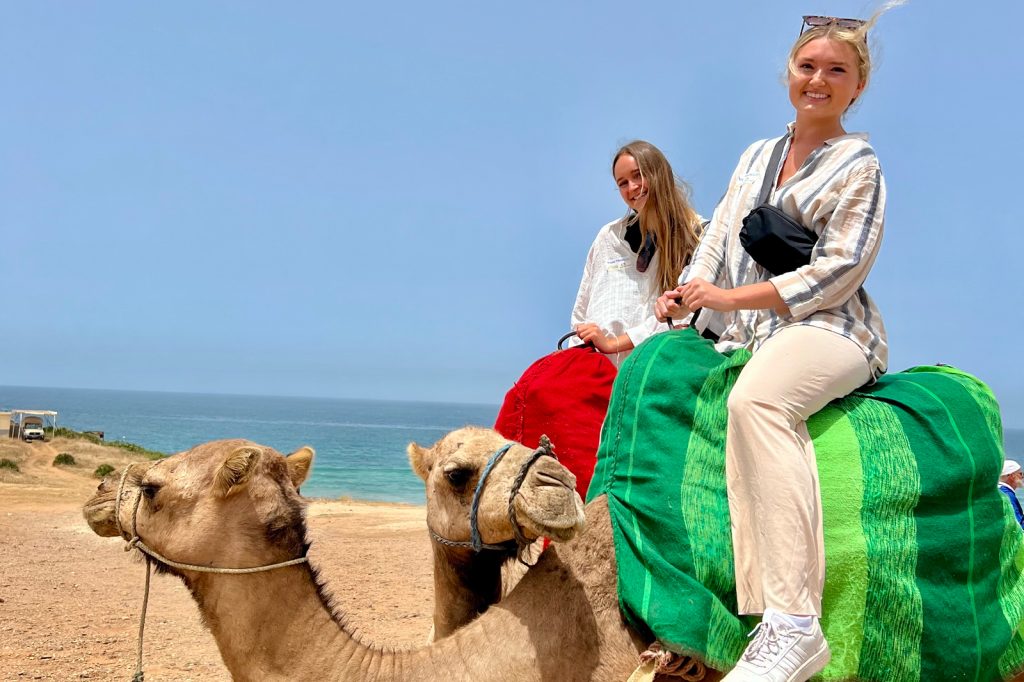 A Spartan rides a camel while studying abroad.