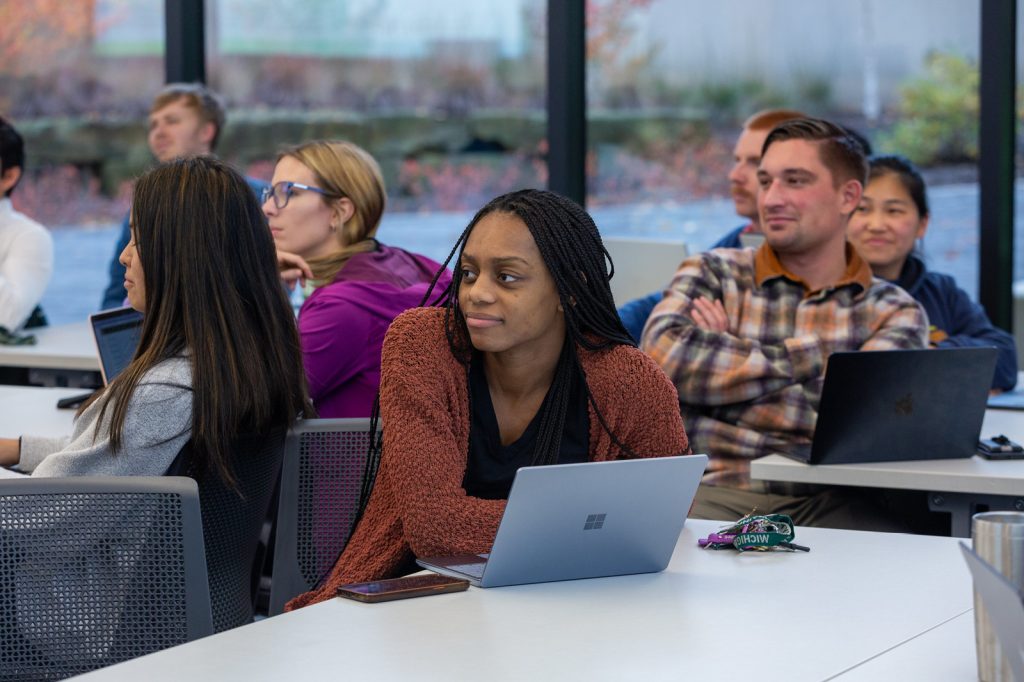 Broad MBA students seated in classroom listen pay attention to a guest lecture.