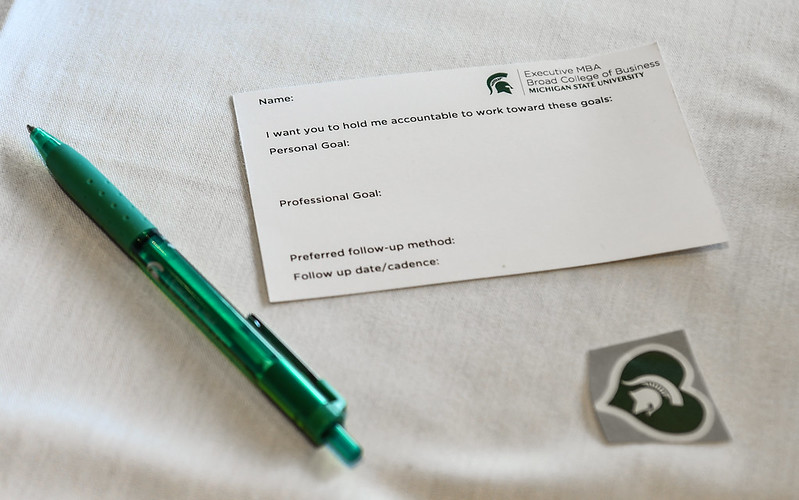 Business card and pen with green heart sticker