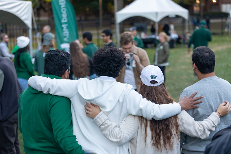 4 people hugging and taking a selfie