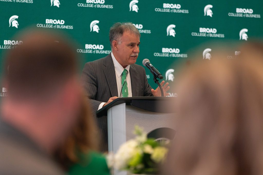 Alumni award winner presenting at podium