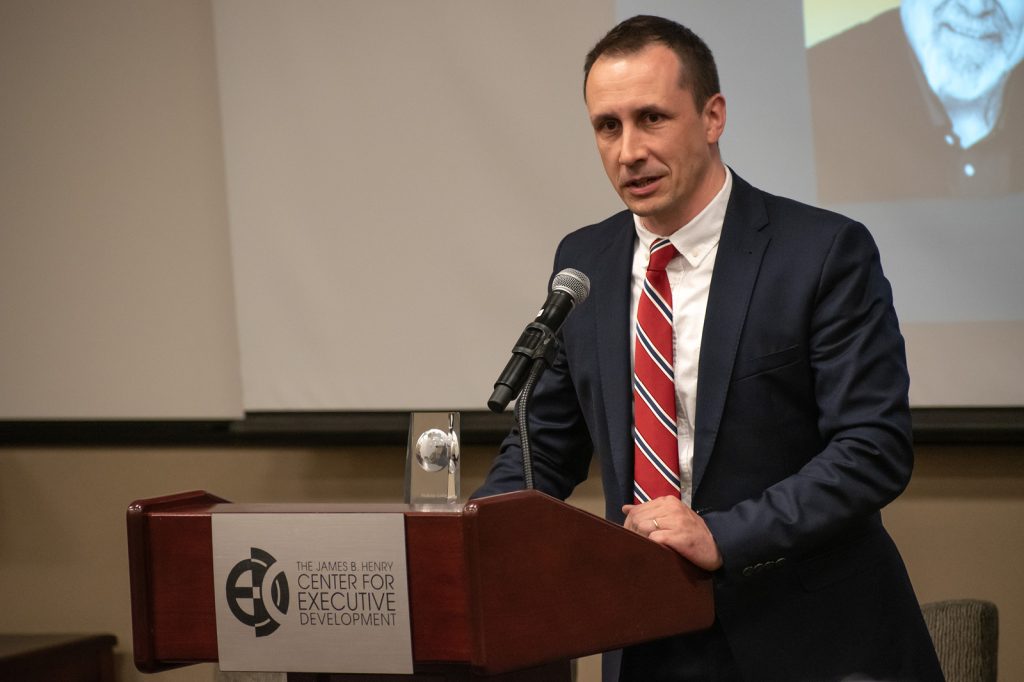 Valerii Kucherenko presenting at podium