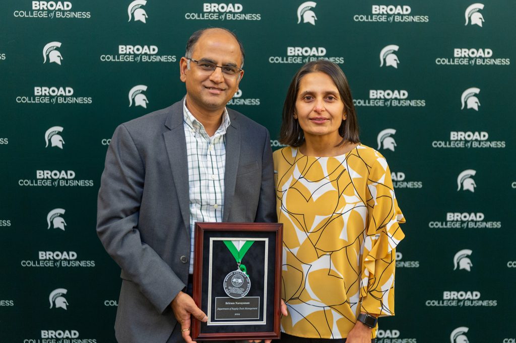 Sriram Narayanan standing with event attendee
