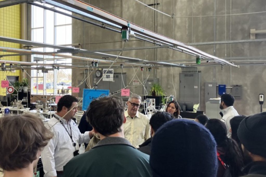 Group of students touring factory floor