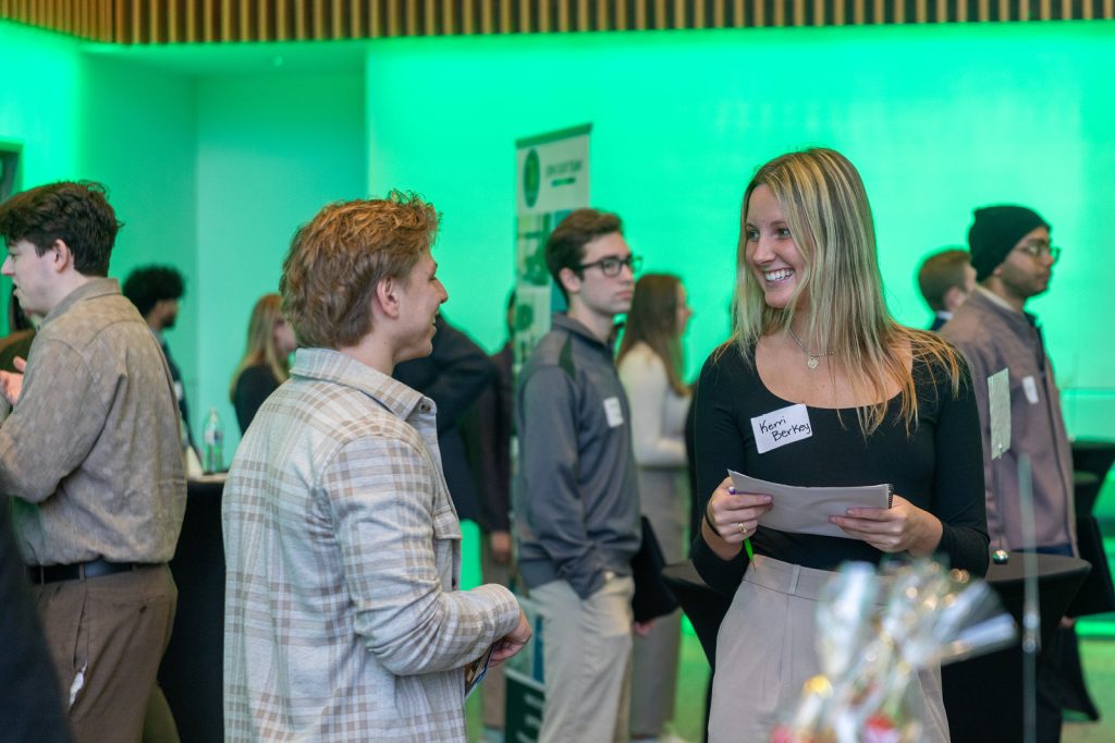 Two event attendees laughing and talking