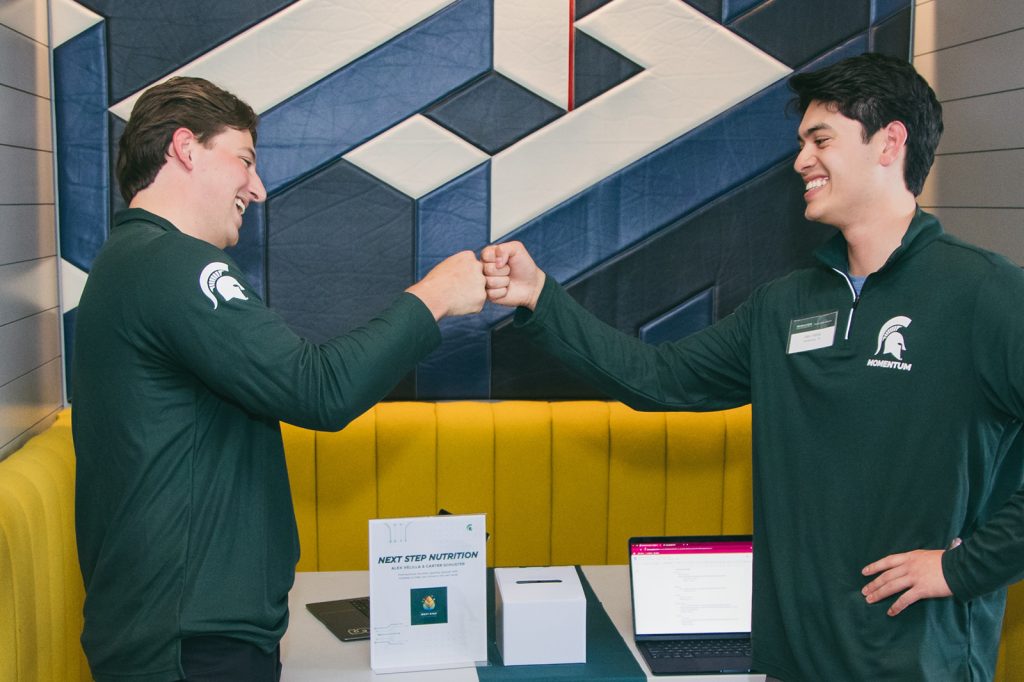 Event attendees fist bumping