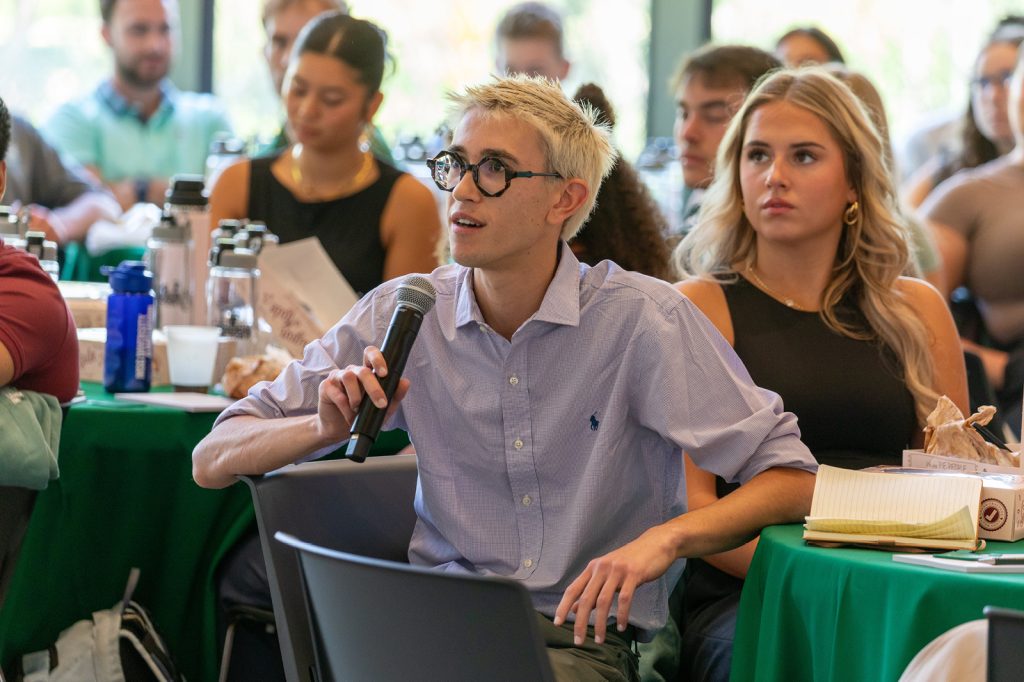 Student speaking into a microphone