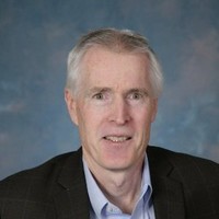 A professional headshot of Steven Finn