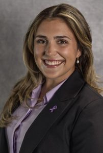 Headshot of a woman with long hair wearing business attire.